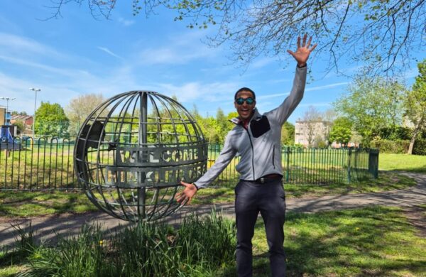 A man posing in the park.