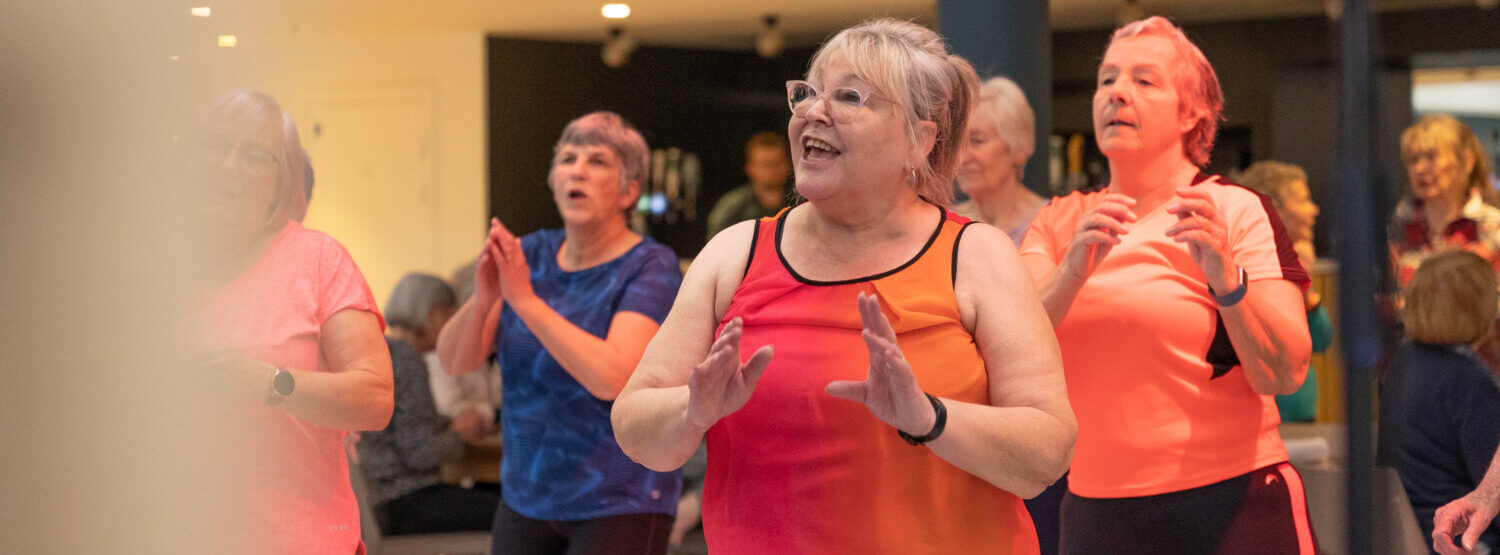 A group of older adults dancing.