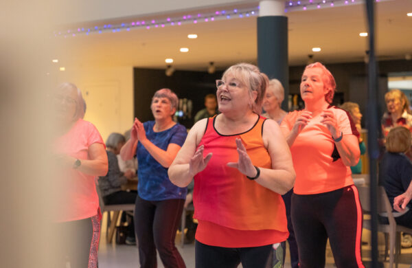 A group of older adults dancing.